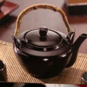 Beautiful black glossy tea pot with wooden handle